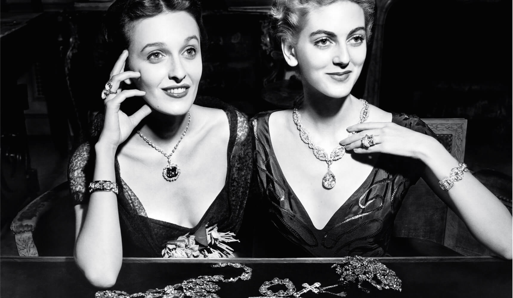 Vintage image of women wearing Harry Winston necklaces at the Harry Winston Court of Jewels