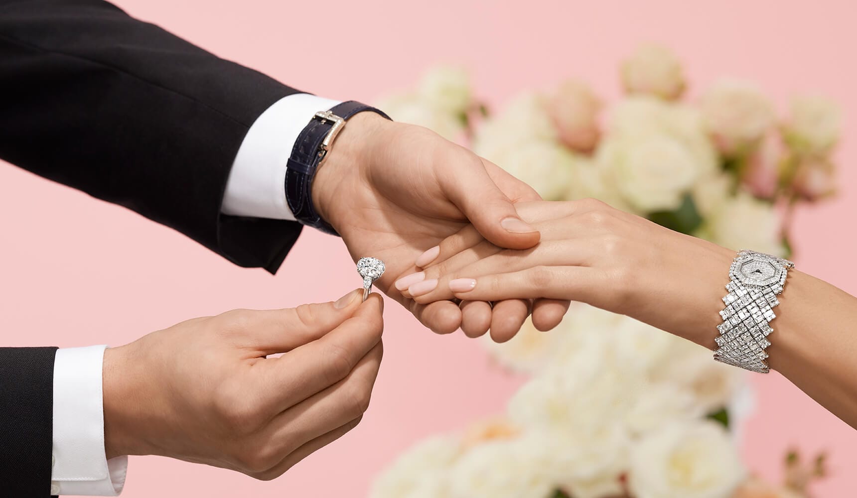 Male placing Diamond Engagement Ring on female hand